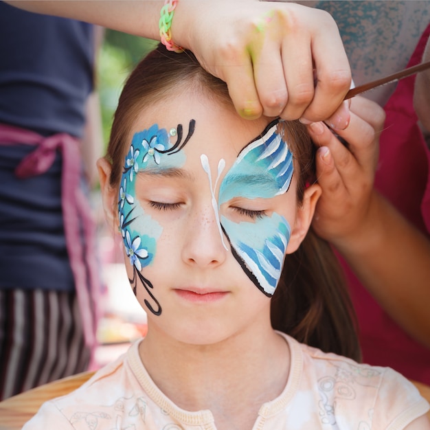 Cute little girl getting a face painting