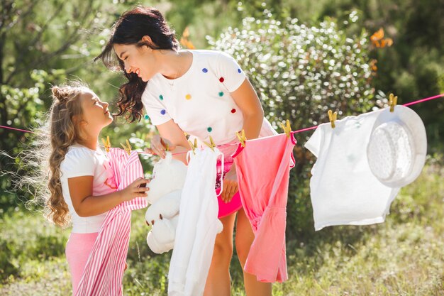 Cute little girl and her mother laundring