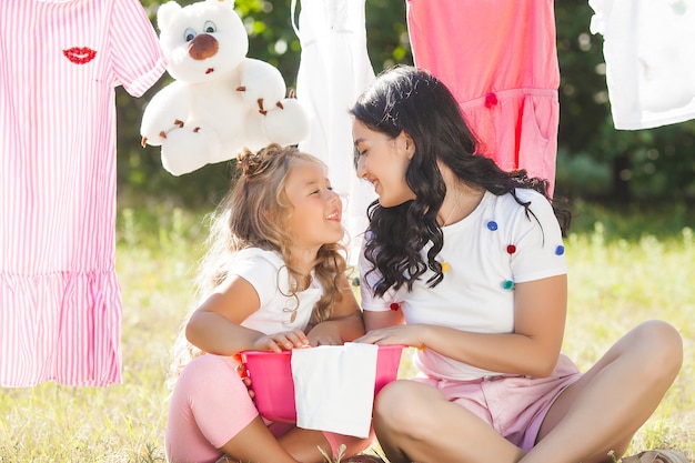 Cute little girl and her mother laundring