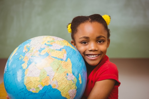 Cute little girl holding globe