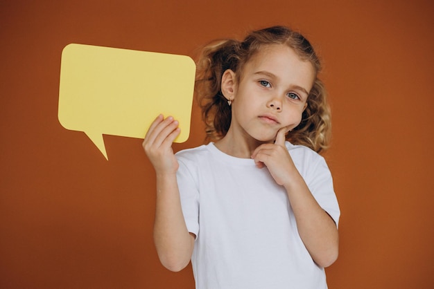 Photo cute little girl holding mind bubbles isolated in studio