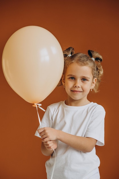 Cute little girl holding one balloon