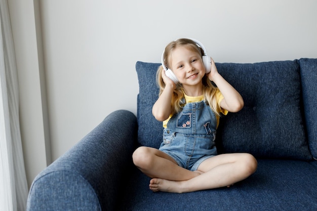 cute little girl at home with headphones