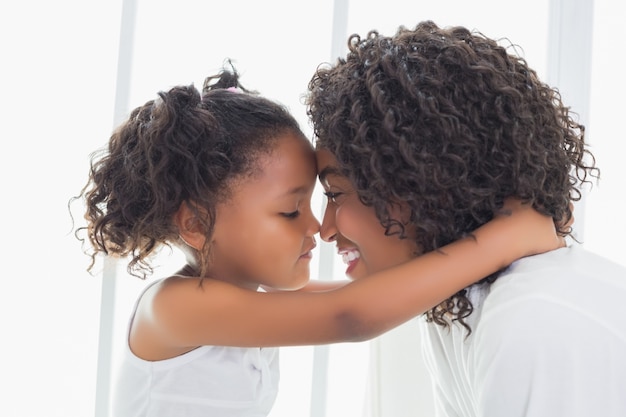 Cute little girl hugging her mother