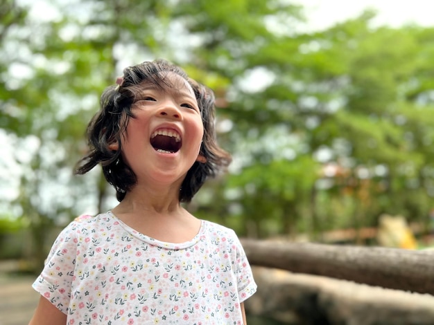 Cute little girl is laughing in the garden