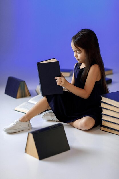 Cute little girl is reading a book