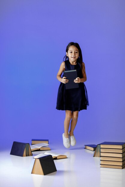 Cute little girl is reading a book