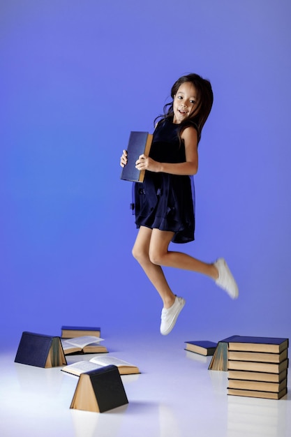 Cute little girl is reading a book