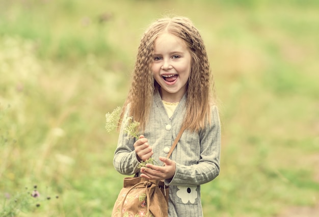 Cute little girl is walking in summer