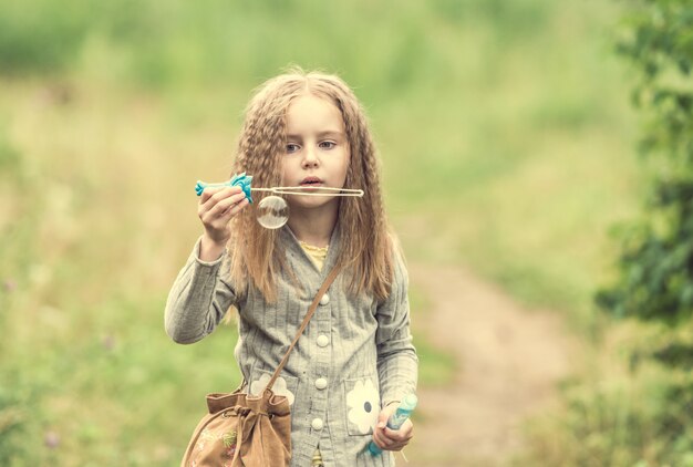 Cute little girl is walking in summer