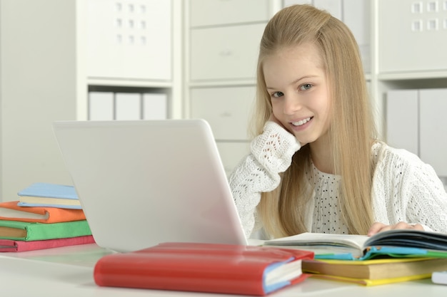 Cute little girl  and  laptop at home