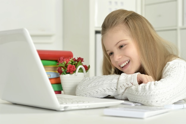 Cute little girl  and  laptop at home