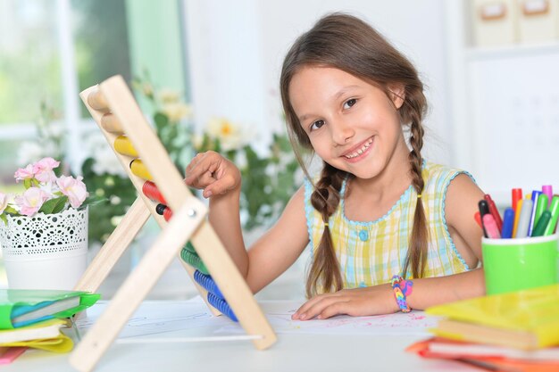 Cute little girl learning to use abacus