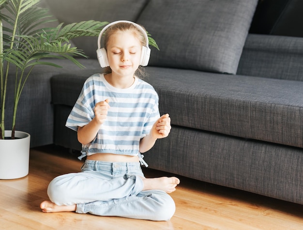 Cute little girl listening to music in headphones