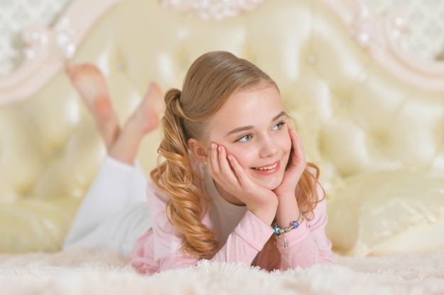 Cute little girl lying on soft fluffy plaid