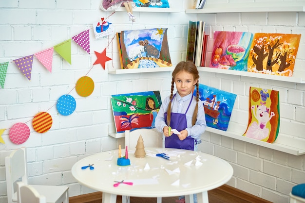 Cute Little Girl Making Christmas Decorations