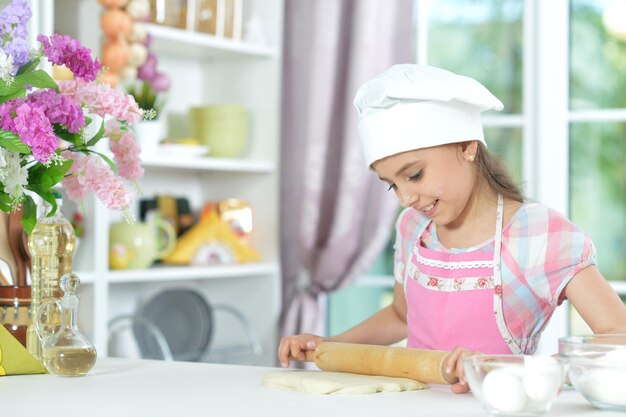 Cute little girl making dinner