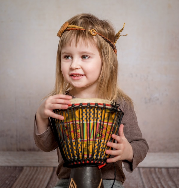 Cute little girl playing drum