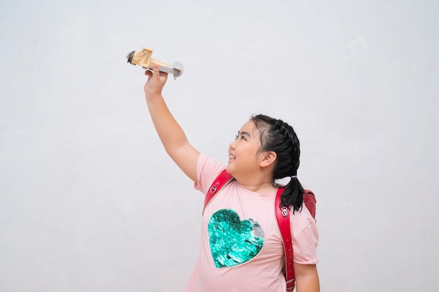 Cute little girl playing with a toy airplane