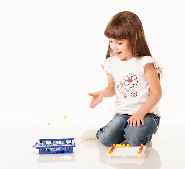 Cute little girl playing with toy.