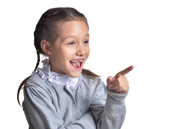 Cute little girl pointing to the right isolated on white background