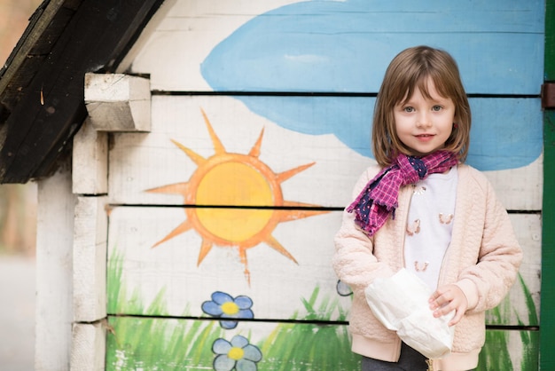 cute little girl portrait while  having fun in playground park on cludy autum day