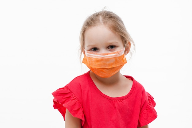 cute little girl posing wearing medical protective mask