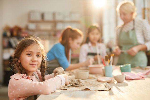 Cute Little Girl in Pottery Class