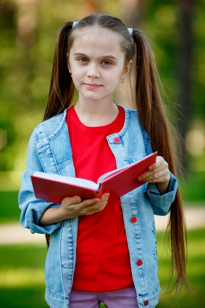 Cute little girl reading book