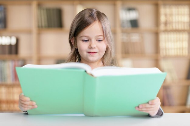 Cute little girl reading book