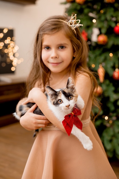 Cute little girl received as a gift kitten for the new year