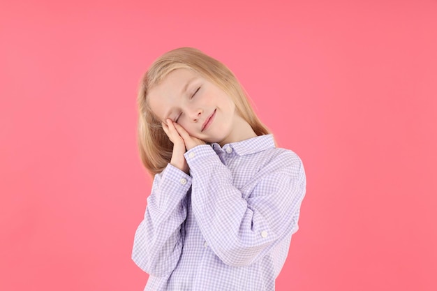 Cute little girl in shirt on pink background