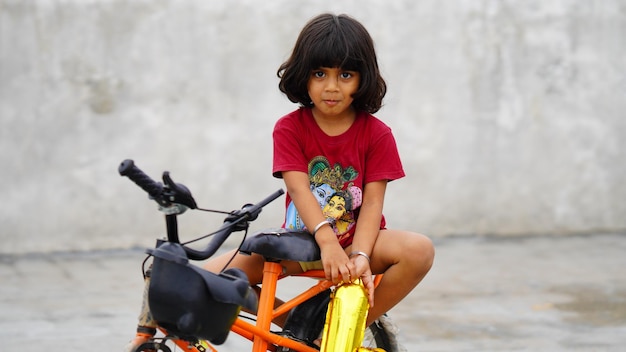 Cute little girl sitting on cycle