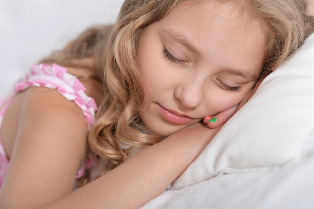 Cute little girl sleeping in a bed