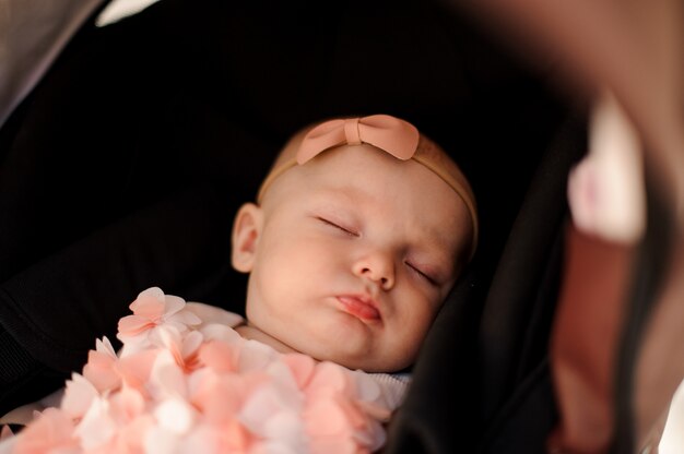 Cute little girl sleeping in her baby carriage