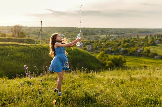 Cute little girl squirting water