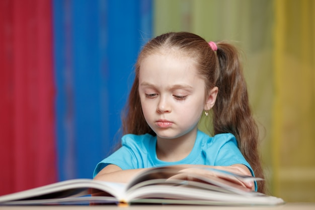 Cute little girl studying at home