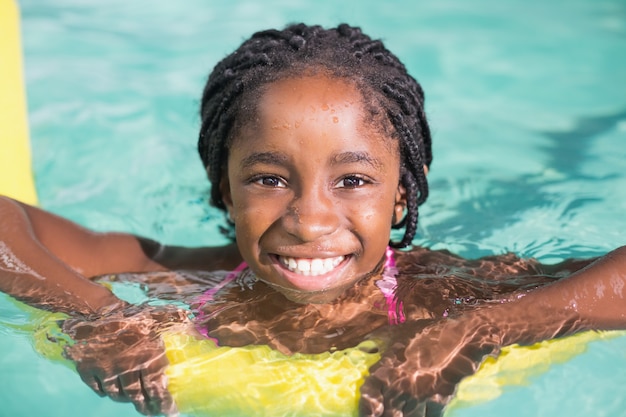 Cute little girl swimming in the pool