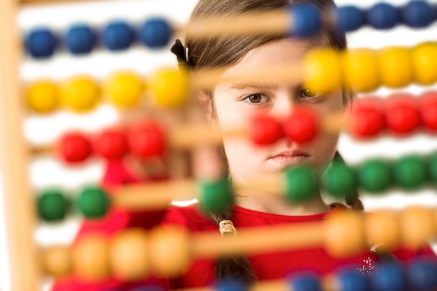 Cute little girl using an abacus