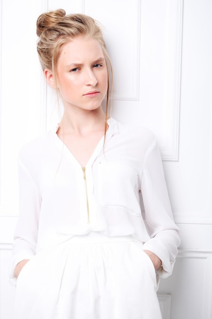 Cute little girl in white dress over white background