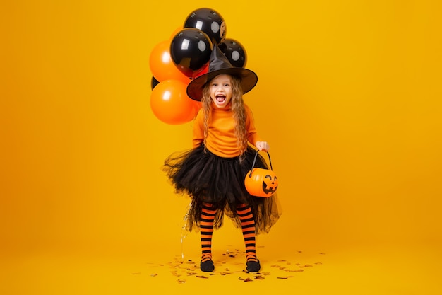 Cute little girl in a witch costume for Halloween