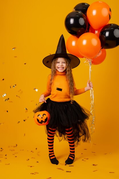 Cute little girl in a witch costume for Halloween