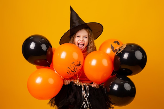 Cute little girl in a witch costume for halloween