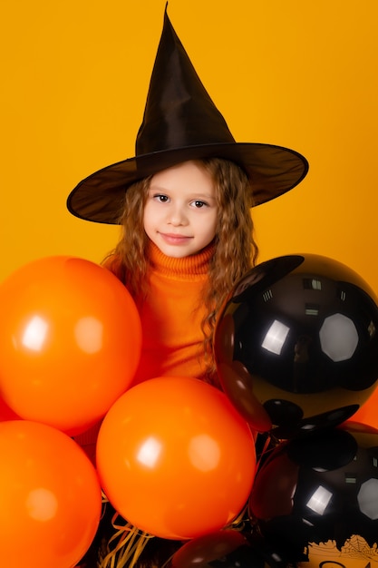Cute little girl in a witch costume for halloween