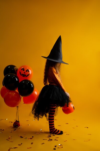 Cute little girl in a witch costume for Halloween