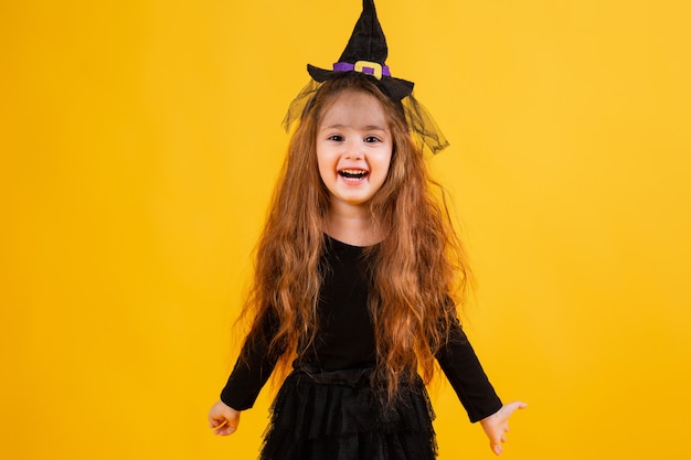 Cute little girl in a witch Halloween costume