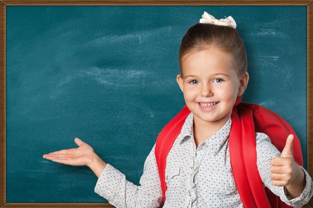 Cute little girl with big red backpack