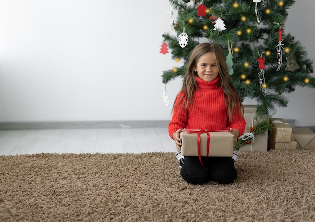 Cute little girl with a Christmas gift