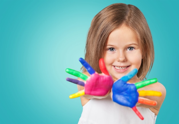 Cute little girl with colorful painted hands on  background