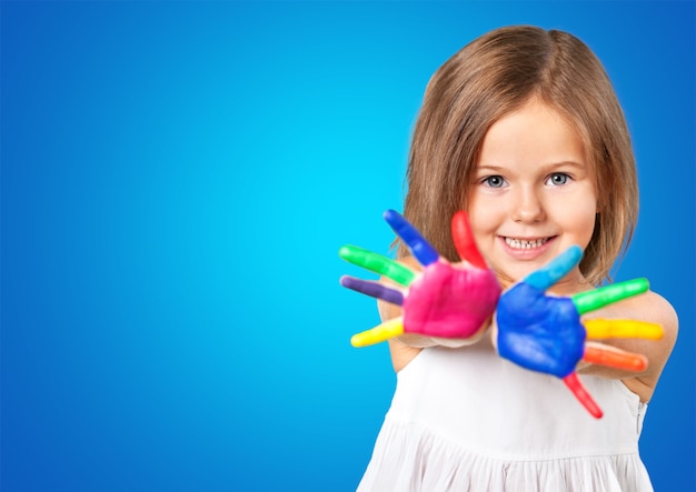 Cute little girl with colorful painted hands on  background